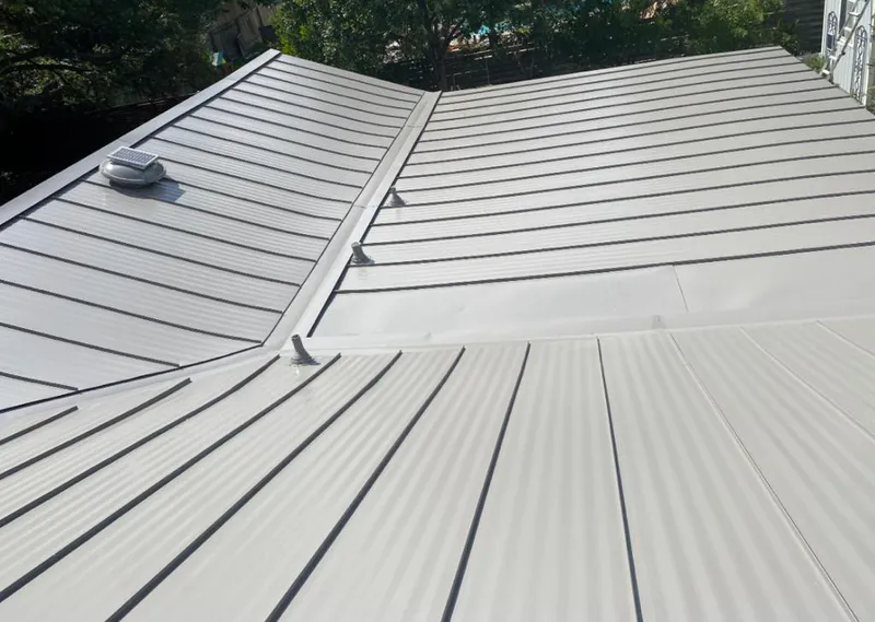 Solar attic fan installed on a metal roof for Roof Ventilation in Winton